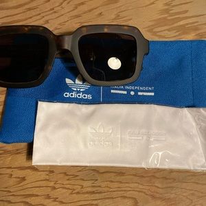 Adidas sunglasses, brown tortoiseshell with case and glass cleaner.